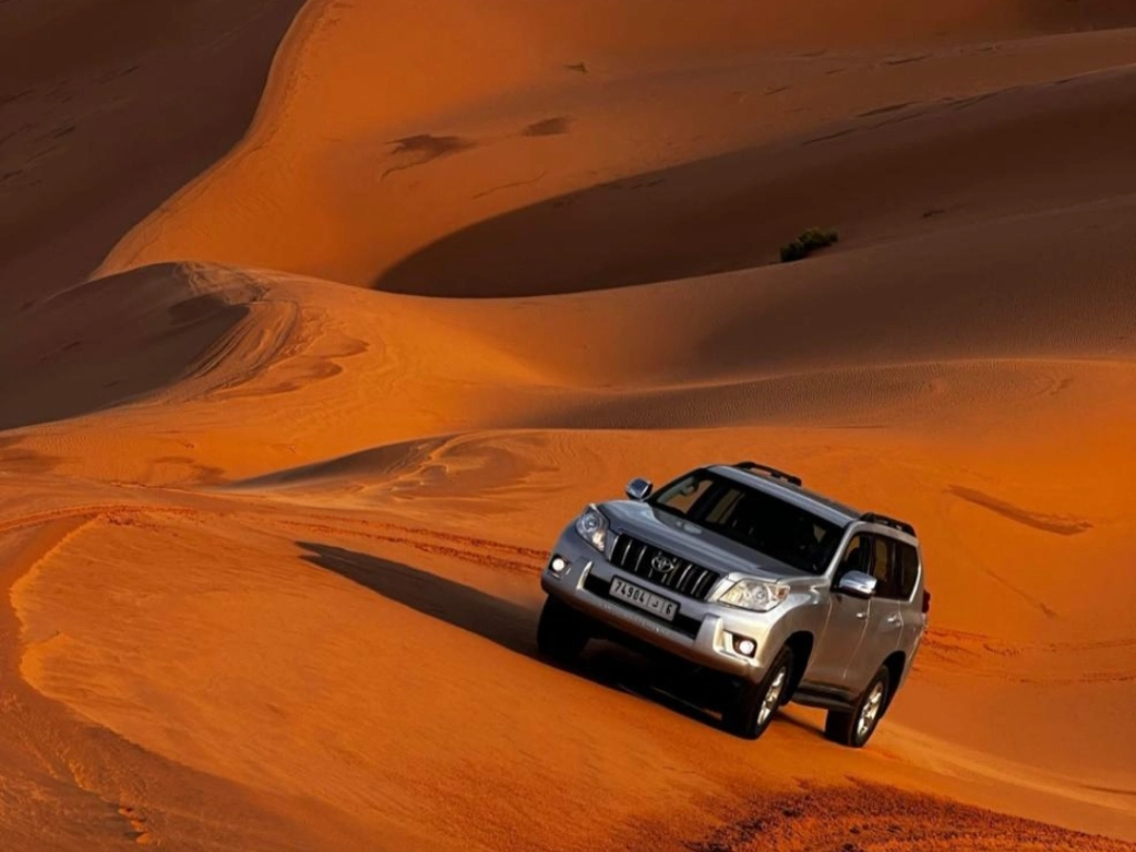 4x4 vehicle driving through diverse Merzouga desert landscape