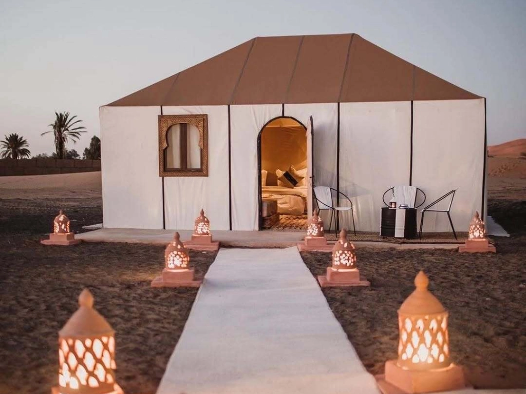 Luxury Merzouga overnight camp with spacious tents featuring private bathrooms and comfortable furnishings
