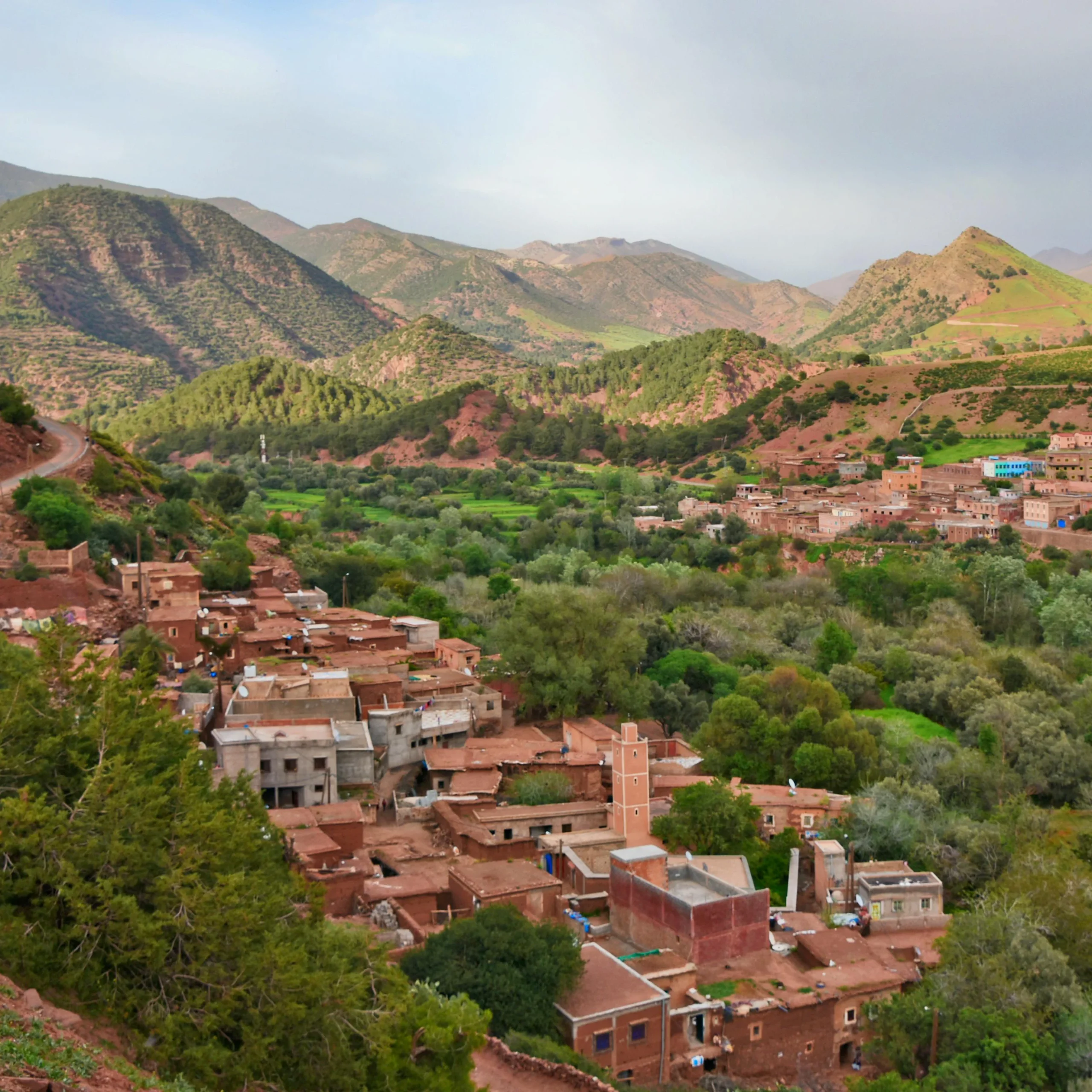 4 days desert tour from Marrakech — High Atlas Mountains with traditional Berber village in green valley red clay houses Day 1 Morocco